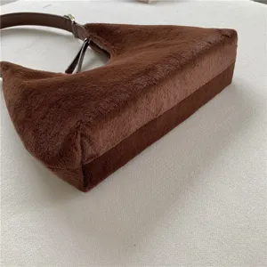Brown plush crescent underarm bag detail, soft fluffy handbag for women autumn winter fashion.