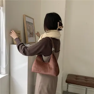 Brown plush crescent shoulder bag detail view, stylish autumn and winter daily accessory.