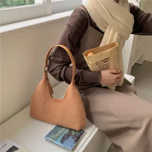 Stylish plush hobo bag for women, cozy fuzzy autumn winter shoulder handbag with soft handle.