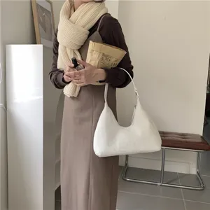 Soft white plush hobo shoulder bag close-up view showing the fuzzy texture and stylish design.