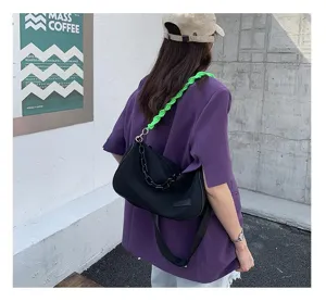 Canvas underarm shoulder bag with neon green braided strap and chain detail for women commute