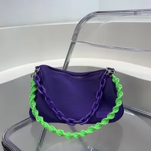Purple canvas underarm bag with green woven strap and chunky chain for women daily commute style.