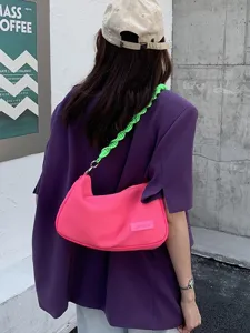 Stylish canvas underarm shoulder bag for women, bright pink handbag with green braided strap.