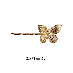 Gold butterfly hairpin elegant side hair clip for women delicate metallic hair accessory fashion.