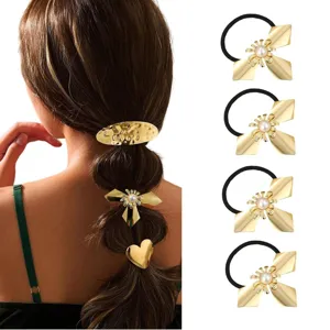 Detailed close-up of golden metal bow hair ties and hair clips showing exquisite texture.