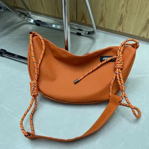 Orange oxford cloth dumpling bag with thick rope straps, trendy niche design for women.