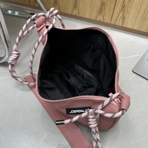 Pink oxford cloth dumpling crossbody bag with knotted strap, large capacity and stylish design.