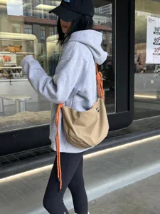 Large capacity nylon dumpling bag with orange knot strap, casual crossbody fitness purse.