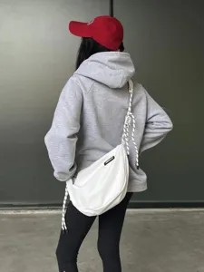 Detailed view of the white nylon dumpling crossbody bag with trendy knot straps for women.