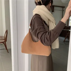Brown plush hobo bag detail shot showing soft fluffy texture and comfortable shoulder wear style.
