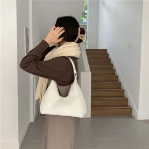 Scene detail of a fluffy white shoulder hobo bag, soft plush material for autumn winter.