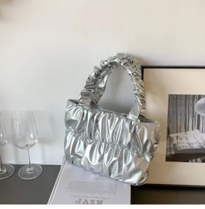 Silver metallic ruched cloud handbag detail, soft pleated shoulder bag showcasing premium texture.