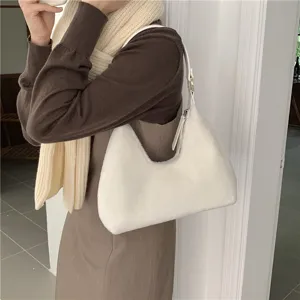 Detailed shot of white plush hobo bag showing soft texture and crescent shape design.