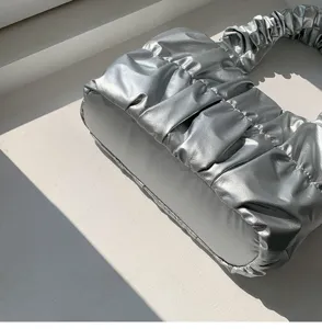 Silver metallic ruched cloud shoulder bag, stylish textured handbag detail showcase.