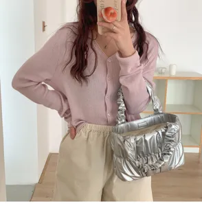 Silver metallic ruffled cloud handbag detail view, stylish fashion accessory for women.