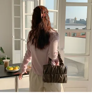 Detailed view of women's trendy casual solid color soft leather ruched cloud handbag style.