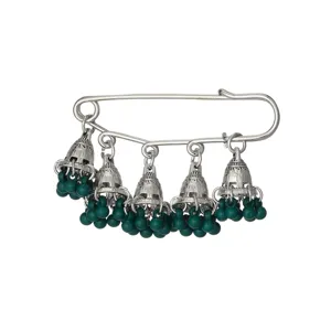 Vintage ethnic style brooch pin with silver jhumka bells and green beaded tassels detail.