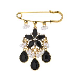 Vintage bohemian style safety pin brooch with black gems and white pearls for women fashion.