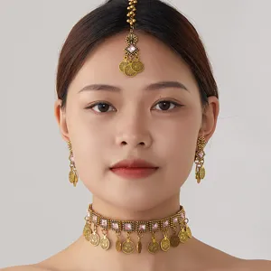 Bohemian vintage gold choker necklace earrings and maang tikka set with pink gemstone accents.