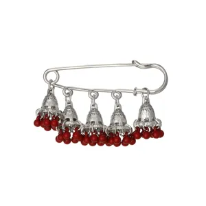 Exquisite vintage safety pin brooch featuring silver jhumka bell charms and red bead tassels.