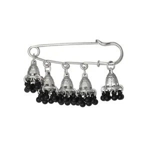 Detailed view of bohemian vintage bell tassel brooch, silver ethnic style safety pin with black beads.
