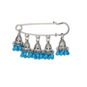 Close-up detail of silver tone safety pin with ethnic style bells and blue bead tassels.
