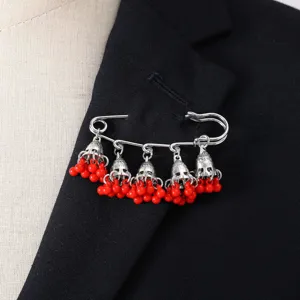 Bohemian retro bell tassel brooch detail, elegant silver safety pin with red bead charms.