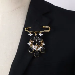 Vintage style safety pin brooch detail, gothic black gem and pearl dangle accessory for women.