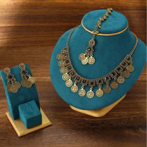 Bohemian vintage jewelry set with necklace and earrings, detailed view of retro fashion style.