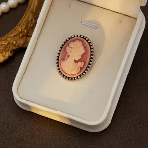 Vintage cameo brooch featuring an elegant lady profile in a beaded metal frame for women.