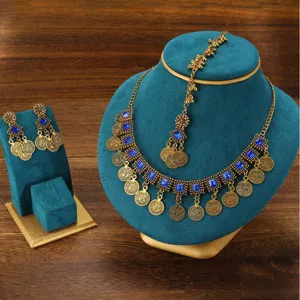 Detailed closeup of bohemian vintage blue stone golden necklace and earrings display set.