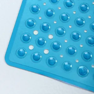 Blue anti-slip bath mat detail showing texture, drainage holes and bubble surface.