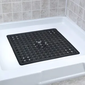 Detailed view of the black rubber anti-slip shower mat with drainage holes and suction cups.