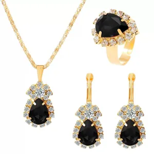 Close-up detail of luxury black gemstone jewelry set, sparkling crystals and gold metal finish.