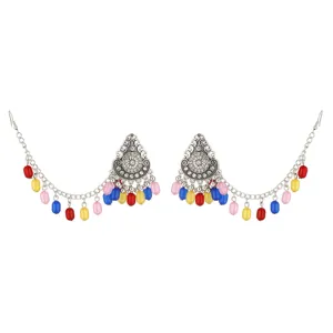Close-up detail of bohemian ethnic style colorful beaded ear chain earrings, silver tone.