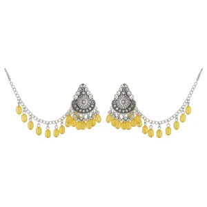 Detailed view of bohemian style silver tone drop earrings with intricate metal and yellow beads.