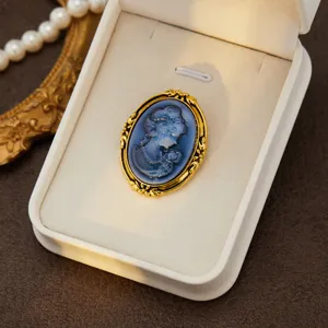 Vintage court style cameo brooch featuring an elegant blue portrait relief with gold frame.