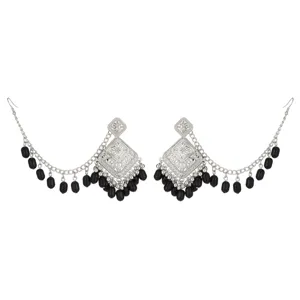 Detailed view of vintage ethnic silver earrings with black beaded chains and hollow carved design.