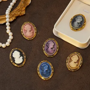Vintage cameo brooch detailed view, classic oval portrait relief pin with gold frame.