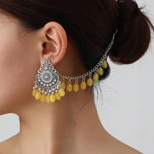 Boho vintage ethnic silver metal drop earring with yellow beads and hair chain detail.