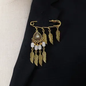 Vintage gold feather brooch pin, bohemian style metal tassel accessory for women detail view