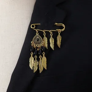 Vintage gold tone feather dangle brooch pin, bohemian ethnic style safety pin jewelry for women.