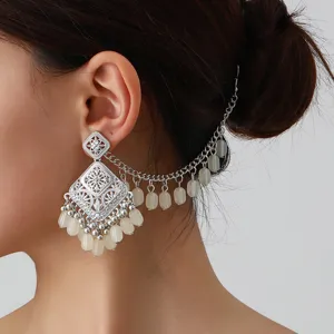 Ethnic vintage hollow silver earrings with tassel chain ear cuffs for women fashion jewelry.
