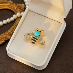 Detailed close-up of the exquisite rhinestone bee brooch, showcasing delicate crystal wings.