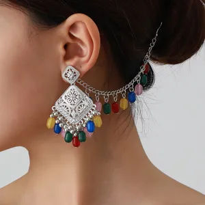 Ethnic hollow carved ear cuff with colorful beaded tassels, vintage silver detail view.