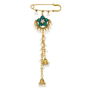Detailed shot of gold-tone safety pin brooch featuring green rhinestones and pearl chains.