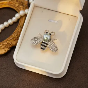 Elegant rhinestone bee brooch pin with faux pearl, vintage chic fashion jewelry for women.