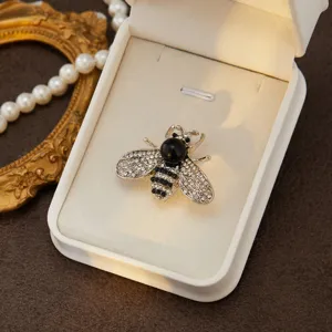 Elegant rhinestone bee brooch for women, sparkling crystal insect lapel pin accessory.