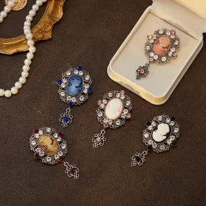 Detailed view of medieval vintage cameo brooch with rhinestone crystals and elegant portrait.