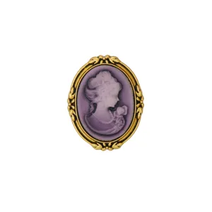 Vintage cameo brooch detailed closeup, elegant purple relief portrait with ornate gold frame.